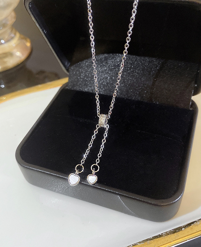 925 Silver plated titanium steel necklace featuring a butterfly and heart pendant, accented with delicate pearl and zirconia details. An elegant piece perfect for everyday wear or gifting.
