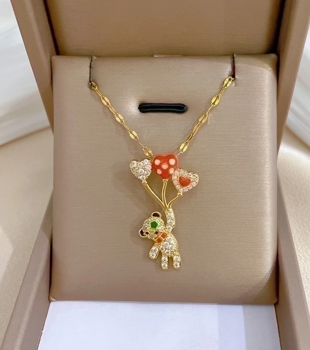 18k Gold-plated necklace featuring a zirconia teddy bear pendant with heart balloon details. A playful yet elegant piece perfect for everyday wear or special occasions.